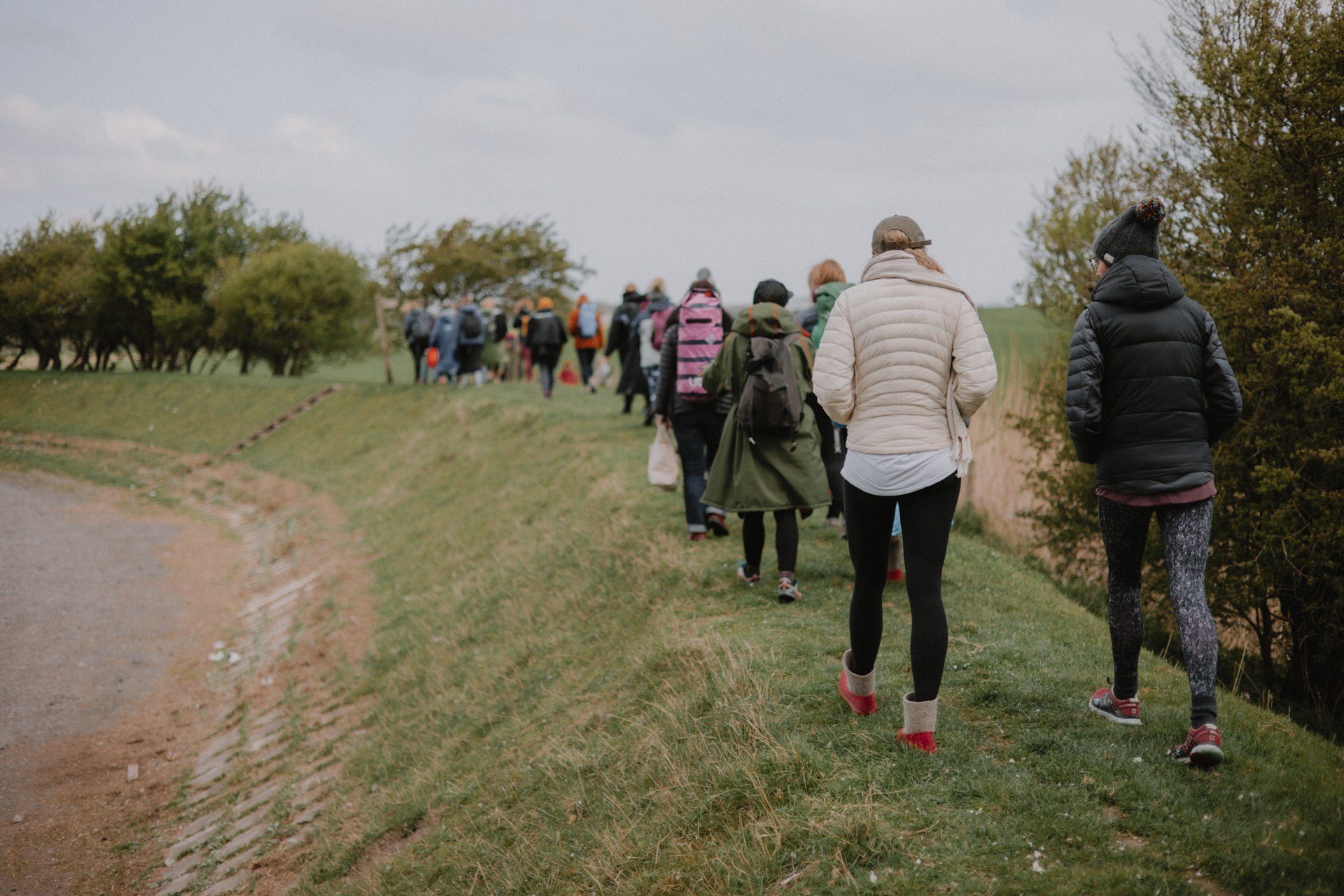 A group walking along the grassy coastal path near Patty’s Barn