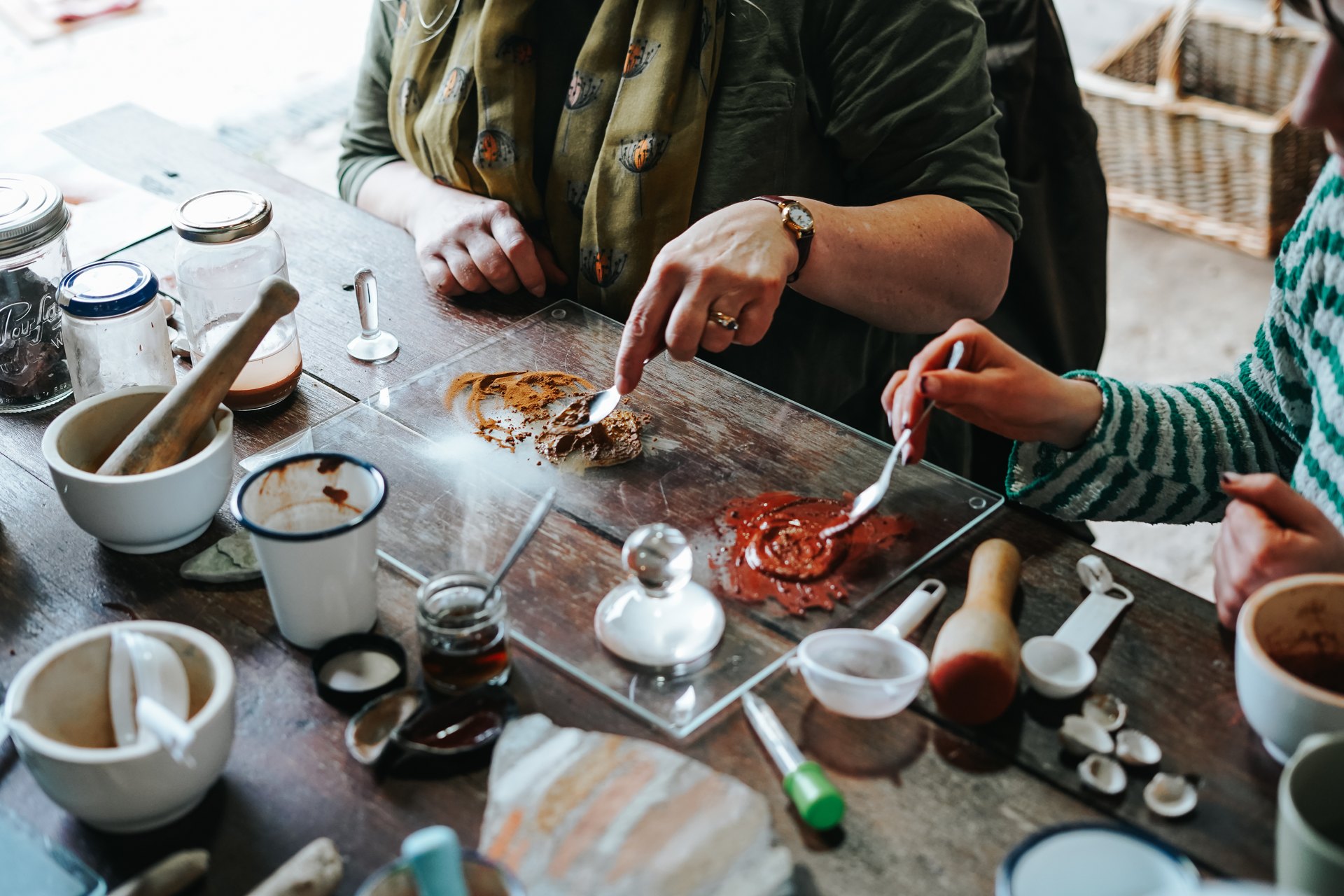 Hands mixing natural colours during a creative workshop