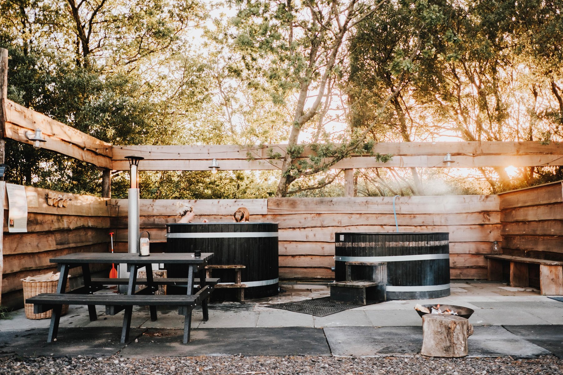 The wood-fired hot tub and cold plunge beneath the trees