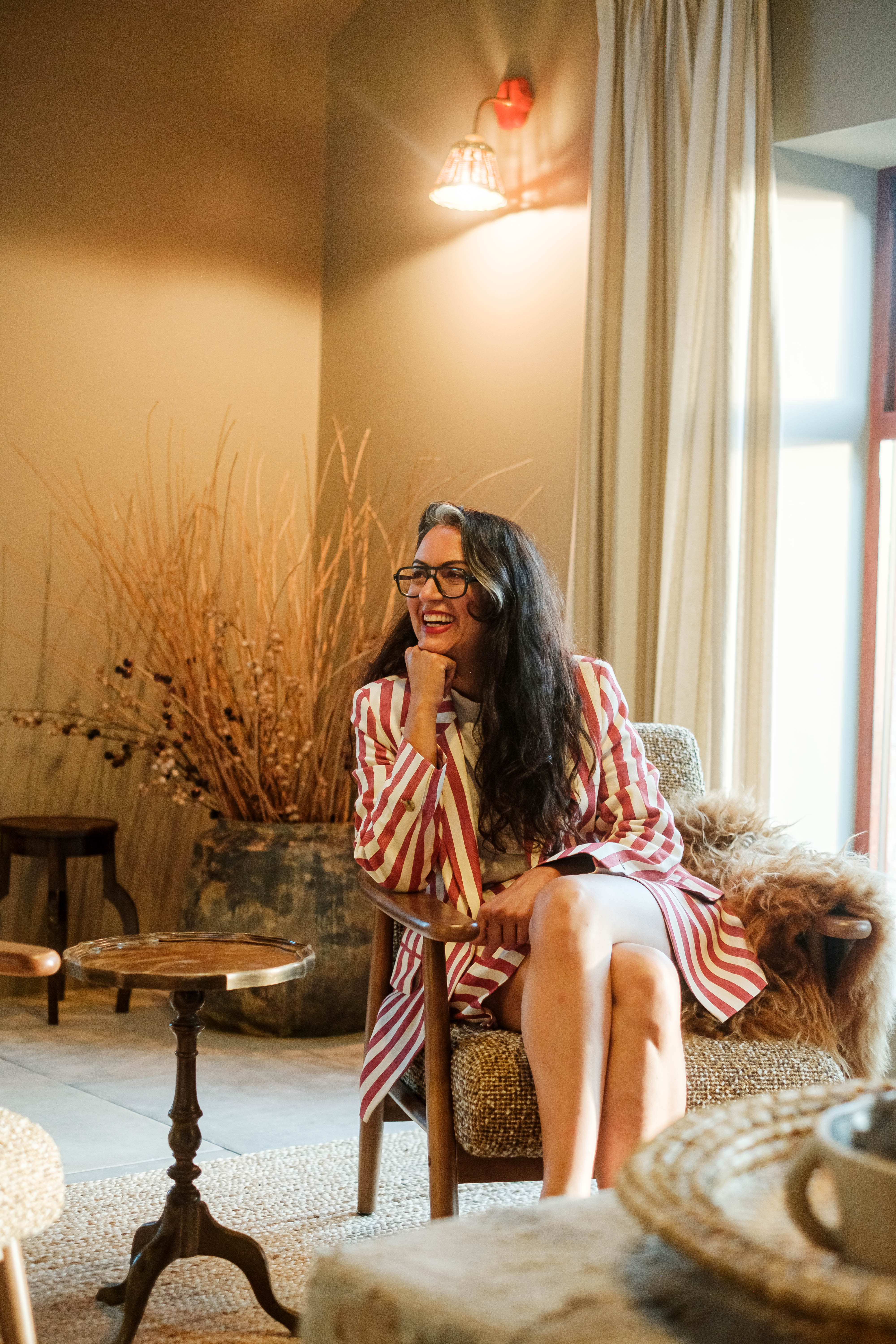 Rita Millat seated in a warmly furnished cottage at Patty’s Barn