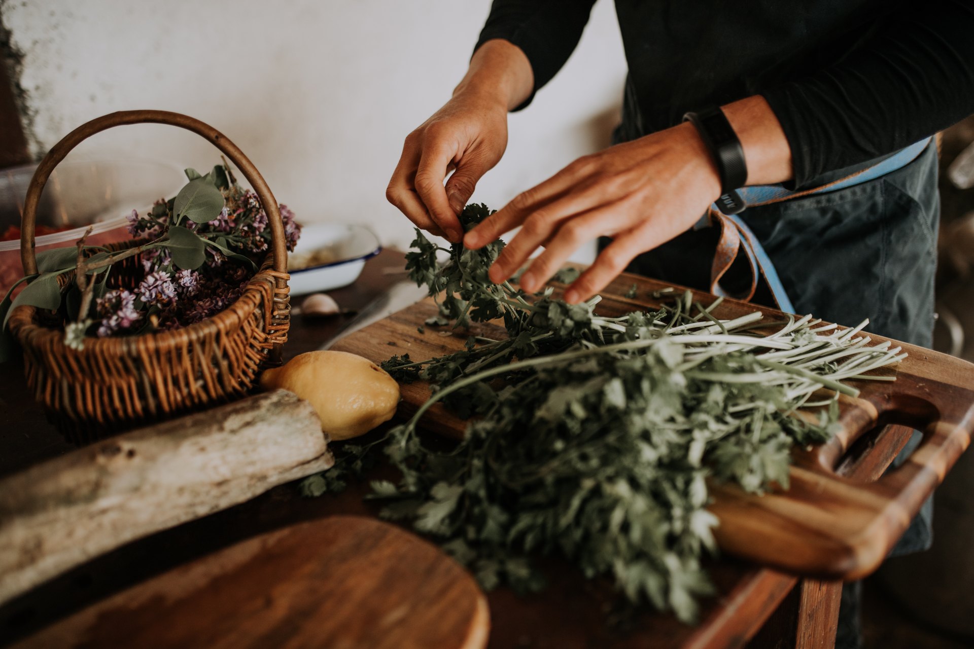 Preparing seasonal ingredients and herbs for a Land + Sea food experience