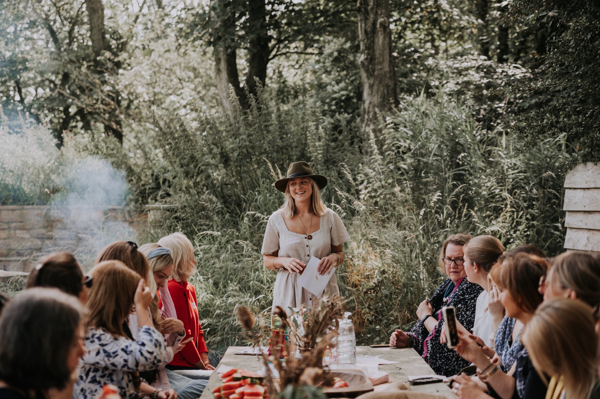 A gathering around a woodland dining table at Patty’s Barn